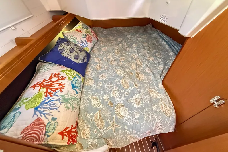 Slide: The Image of Cozy cabin bed in 2014 Bavaria Cruiser 37 yacht with nautical-themed bedding. - 18