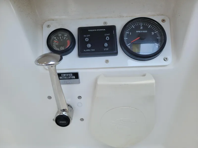 Slide: The Image of Close-up of the control panel with lever and gauges on a 2014 Bavaria Cruiser 37. - 23