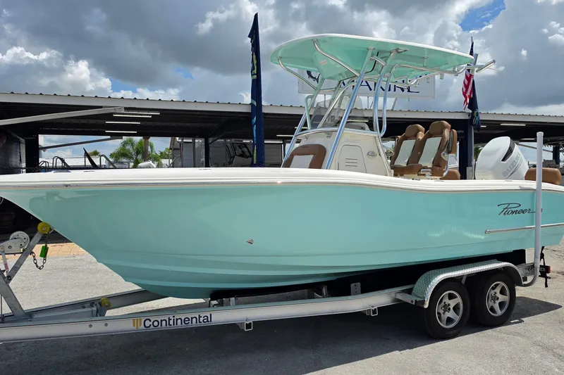 The Image of 2026 Pioneer 222 Sportfish boat on trailer under cloudy sky. - 1