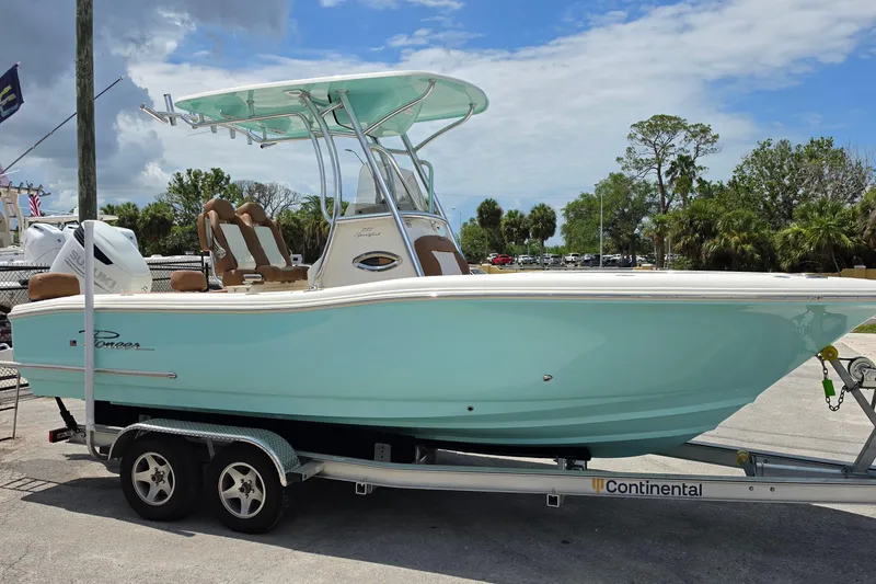 Slide: The Image of 2026 Pioneer 222 Sportfish boat on trailer, featuring sleek design and mint green hull. - 6