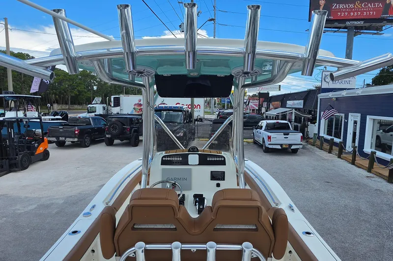 Slide: The Image of 2026 Pioneer 222 Sportfish boat with advanced Garmin navigation, parked in a dealership lot. - 8