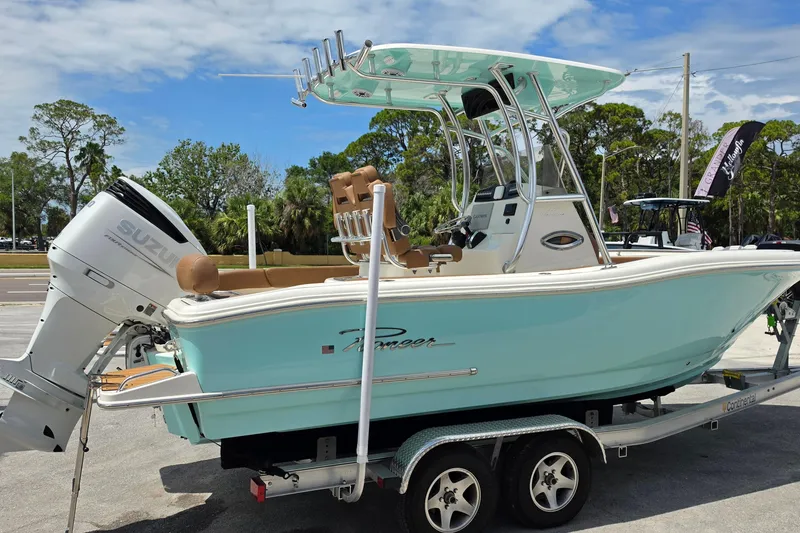 Slide: The Image of 2026 Pioneer 222 Sportfish boat on trailer with Suzuki outboard motor, parked outdoors. - 5