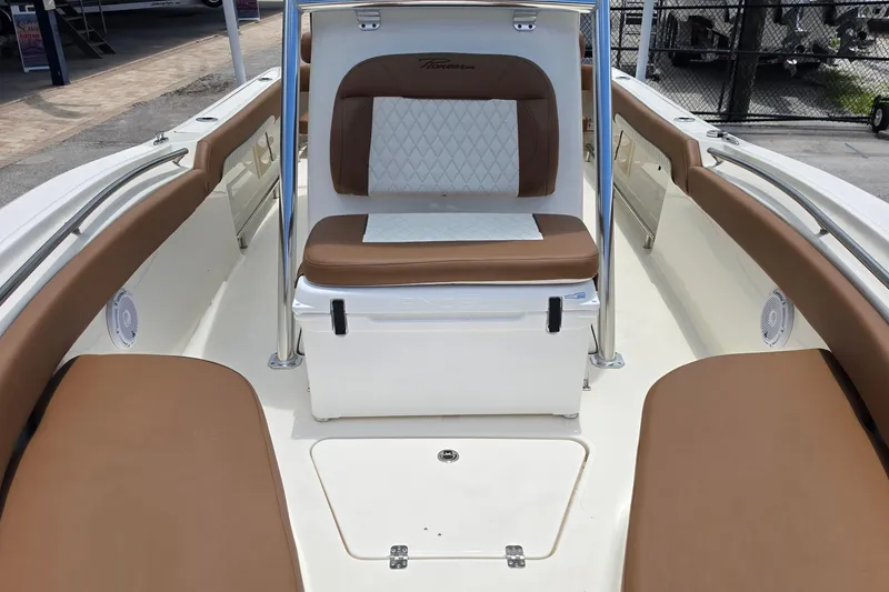 Slide: The Image of 2026 Pioneer 222 Sportfish boat interior with brown and white seating, spacious layout. - 17