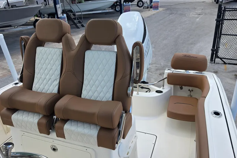 Slide: The Image of 2026 Pioneer 222 Sportfish boat interior with luxurious brown and white seating. - 13
