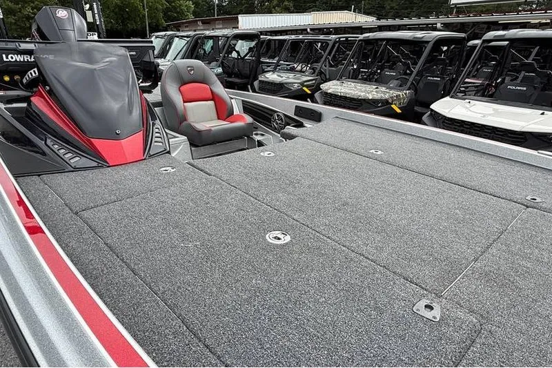 Slide: The Image of 2024 Triton 20XP Patriot boat with spacious deck and red-accented seat. - 97