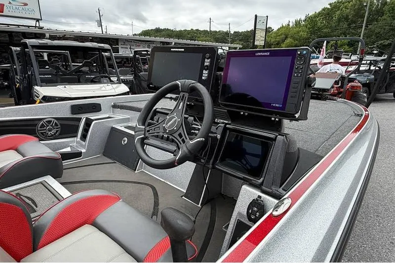 Slide: The Image of 2024 Triton 20XP Patriot boat interior with advanced navigation systems and steering wheel. - 2