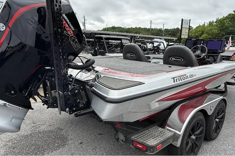 Slide: The Image of 2024 Triton 20XP Patriot boat with powerful engine, sleek design, and dual seats. - 100