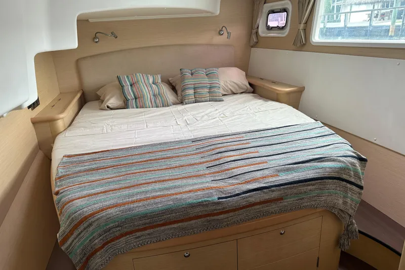 Slide: The Image of Cozy cabin interior of 2010 Lagoon 440 catamaran with striped bedding and pillows. - 57