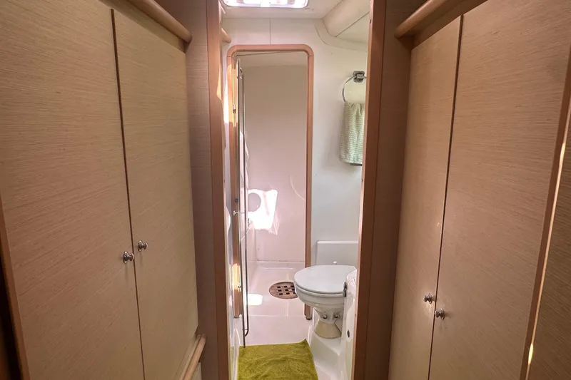 Slide: The Image of Interior of 2010 Lagoon 440 yacht bathroom with wooden cabinets and compact design. - 51