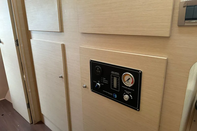 Slide: The Image of Control panel on a 2010 Lagoon 440 yacht interior, featuring gauges and switches. - 45