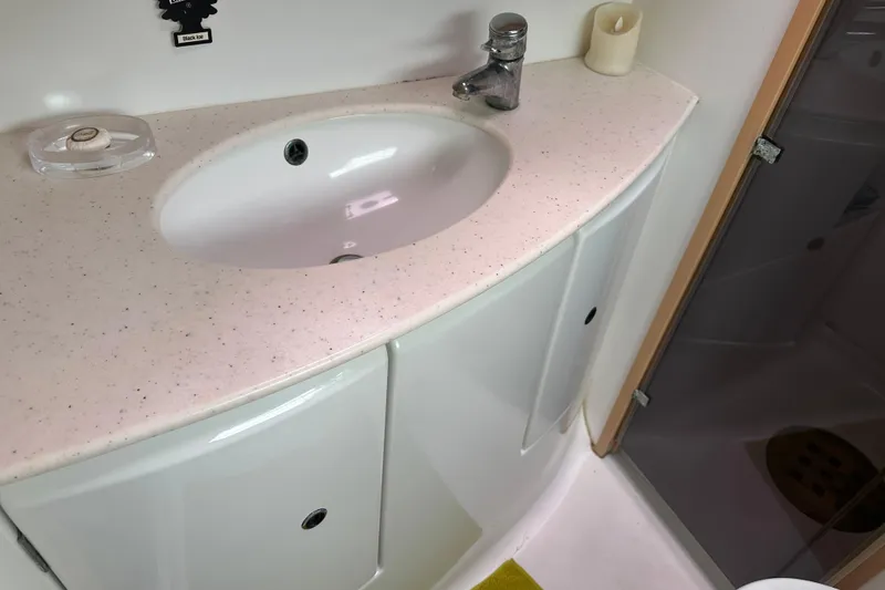 Slide: The Image of Bathroom sink area in a 2010 Lagoon 440 yacht, featuring a modern faucet and countertop. - 53