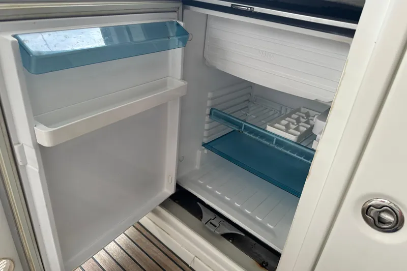 Slide: The Image of Open fridge on Lagoon 440 yacht, 2010 model, with empty shelves and ice tray. - 67