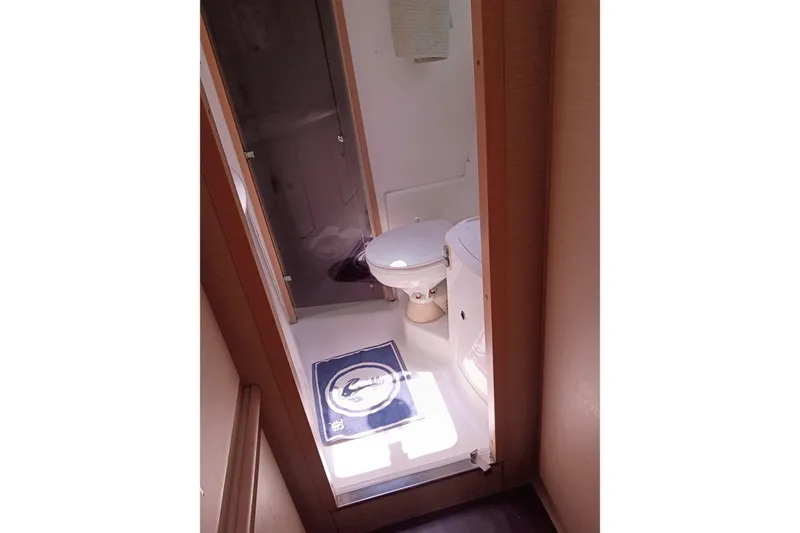 Slide: The Image of Bathroom interior of a 2010 Lagoon 440 yacht, featuring a toilet and shower area. - 32