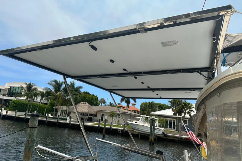 Slide: The Image of Solar panels on a 2010 Lagoon 440 catamaran docked by waterfront homes. - 20