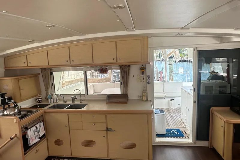 Slide: The Image of Interior of a 2010 Lagoon 440 with a kitchen and view of the cockpit. - 39
