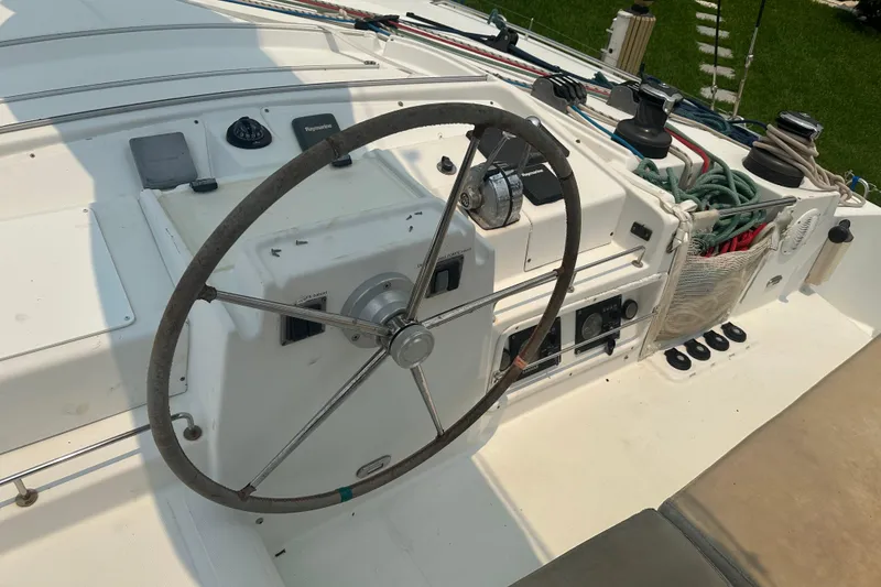Slide: The Image of Steering wheel and controls of a 2010 Lagoon 440 catamaran yacht. - 15