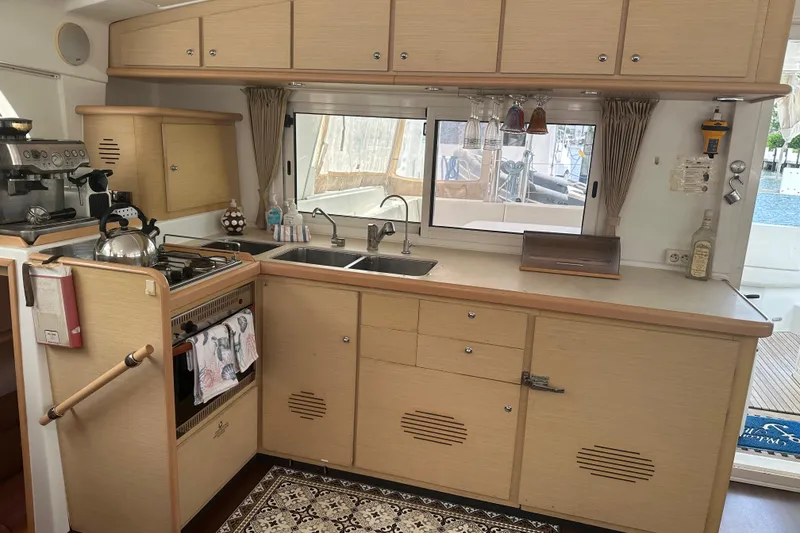 Slide: The Image of Modern kitchen interior of 2010 Lagoon 440 yacht with appliances and wooden cabinetry. - 38
