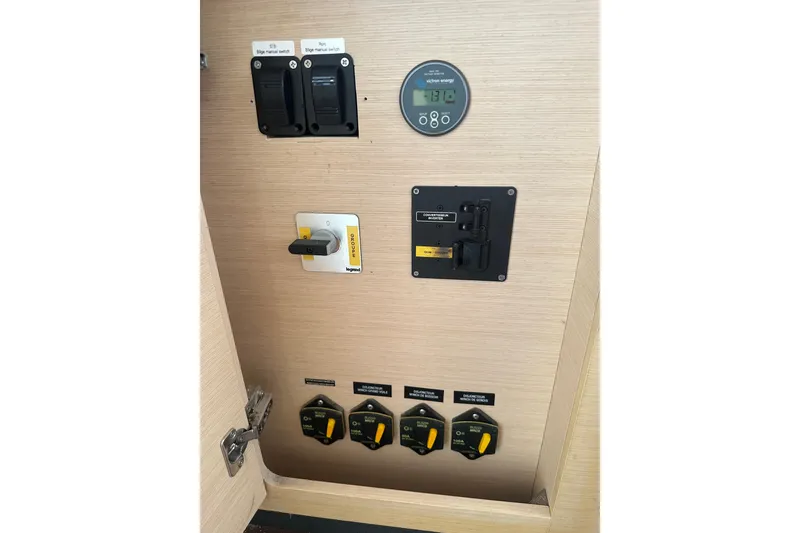 Slide: The Image of Electrical control panel of a 2010 Lagoon 440 yacht, featuring switches and gauges. - 29