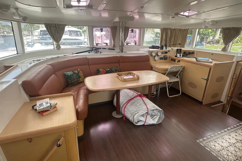 Slide: The Image of Interior of 2010 Lagoon 440 catamaran with seating, table, and navigation area. - 35