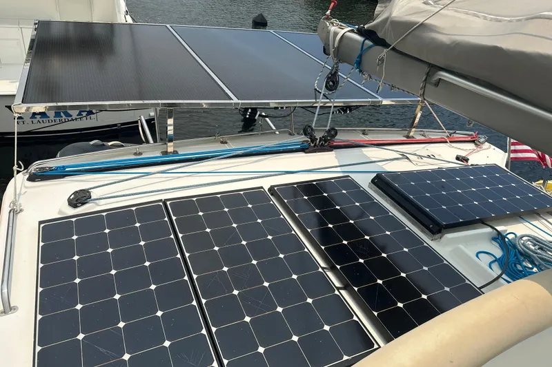 Slide: The Image of Solar panels on a 2010 Lagoon 440 catamaran, docked near water. - 18
