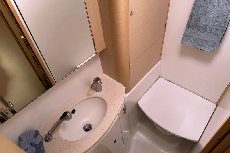 Slide: The Image of Compact bathroom in 2010 Lagoon 440 yacht with sink, mirror, and towel. - 58