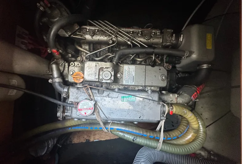 Slide: The Image of Engine compartment of a 2010 Lagoon 440 catamaran, showing mechanical components and hoses. - 71