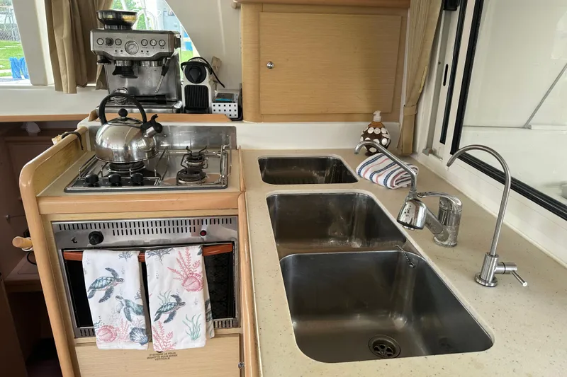 Slide: The Image of Galley kitchen in 2010 Lagoon 440 catamaran with stove, sink, and coffee maker. - 41