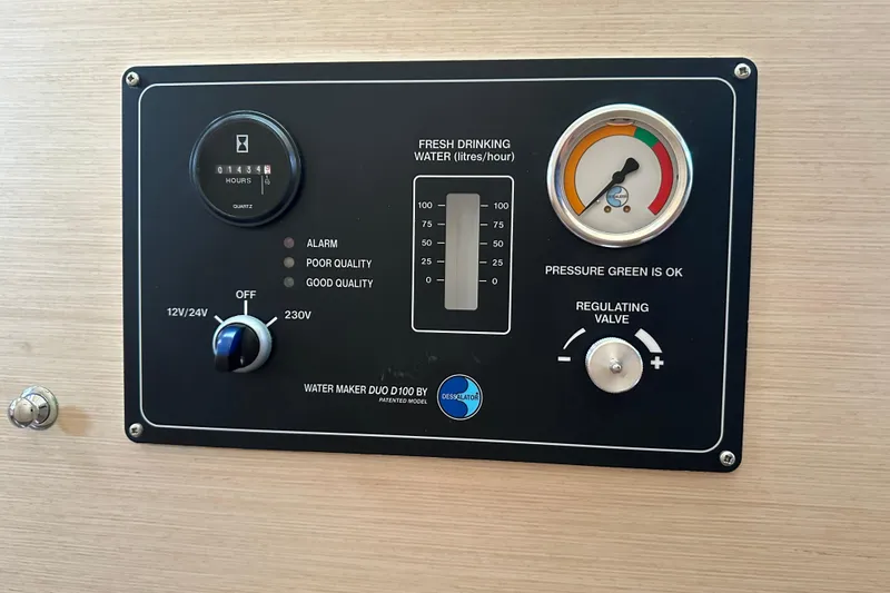 Slide: The Image of Control panel of a 2010 Lagoon 440 water maker, showing pressure and quality indicators. - 46