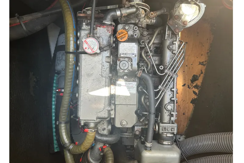 Slide: The Image of Engine compartment of a 2010 Lagoon 440 catamaran, showcasing mechanical components and hoses. - 72