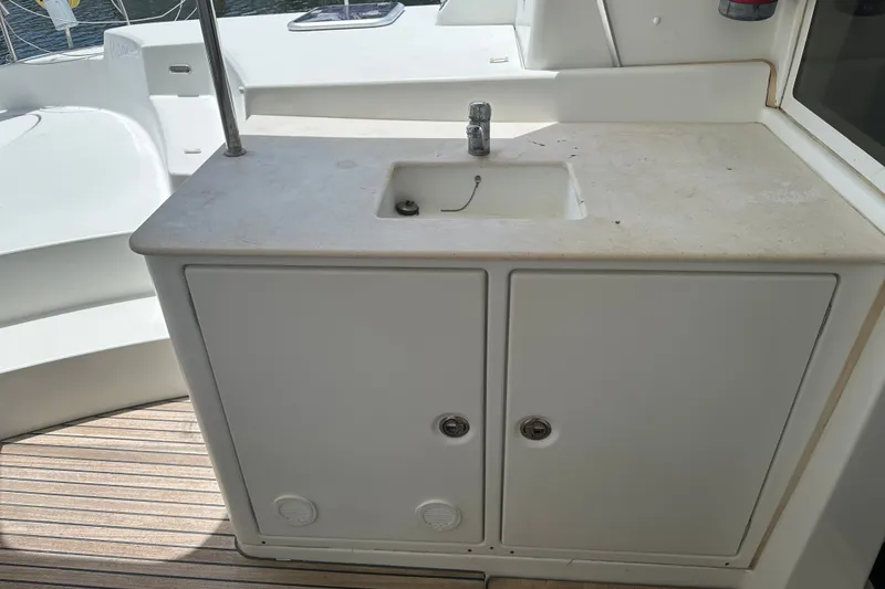 Slide: The Image of Outdoor sink and storage on a 2010 Lagoon 440 catamaran deck. - 63