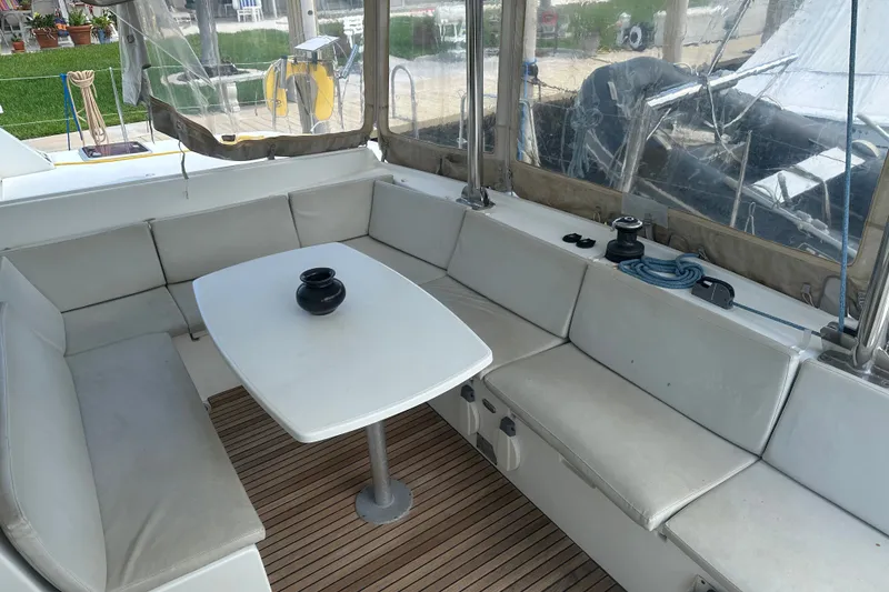 Slide: The Image of Spacious seating area on a 2010 Lagoon 440 yacht with a table and cushions. - 65