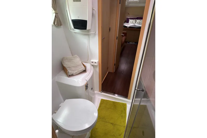 Slide: The Image of Bathroom interior of 2010 Lagoon 440 yacht, featuring toilet and shower area. - 52