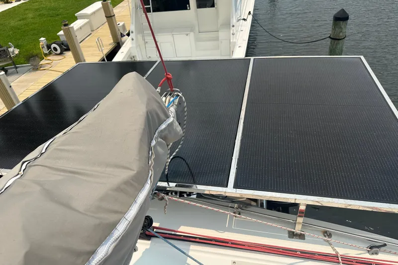 Slide: The Image of Solar panels on a 2010 Lagoon 440 catamaran docked by the water. - 19