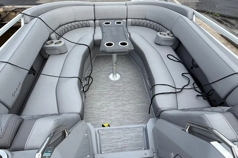Slide: The Image of 2023 Bennington 25RTSB pontoon boat interior with gray seating and central table. - 12