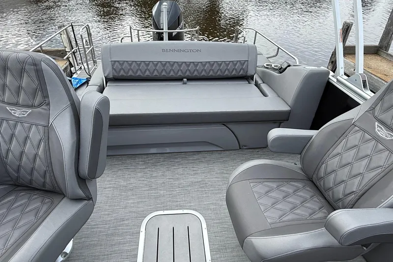 Slide: The Image of 2023 Bennington 25RTSB boat interior with luxurious gray seating and diamond stitching. - 4