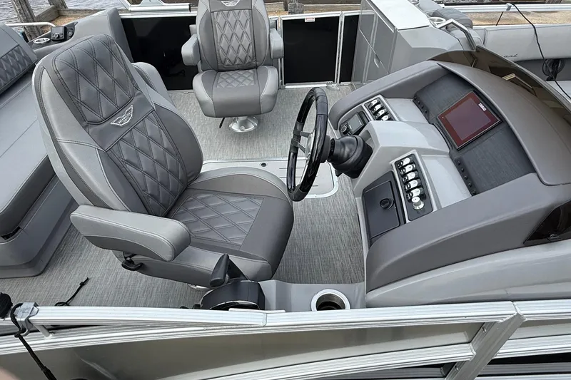 Slide: The Image of Interior of 2023 Bennington 25RTSB boat with luxurious seating and modern dashboard controls. - 6