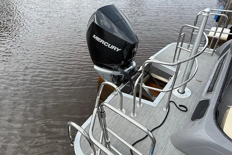 Slide: The Image of 2023 Bennington 25RTSB boat with Mercury outboard motor on calm water. - 8