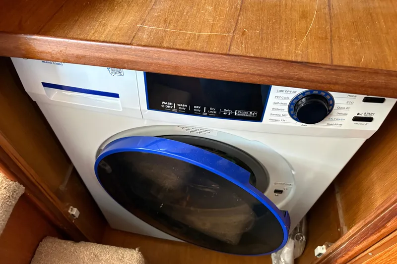 Slide: The Image of Compact marine washer-dryer combo in 1986 CHB Ponderosa boat, wooden cabinetry. - 40