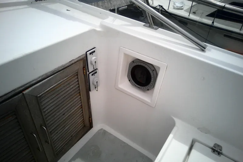 Slide: The Image of 1986 CHB Ponderosa boat deck with wooden cabinet and circular hatch. - 14