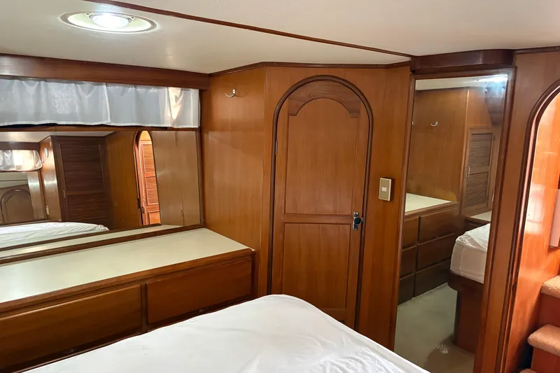 Slide: The Image of Interior of 1986 CHB Ponderosa yacht with wooden cabinetry and mirrored surfaces. - 36