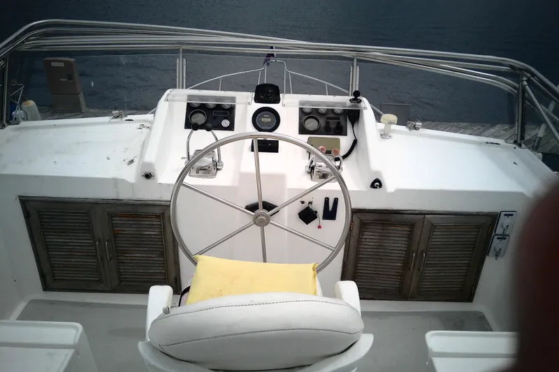 Slide: The Image of Helm of 1986 CHB Ponderosa boat with steering wheel and control panels. - 12