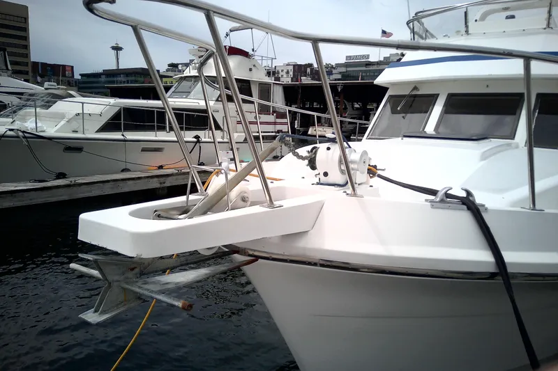 Slide: The Image of 1986 CHB Ponderosa yacht docked at marina with cityscape background. - 5