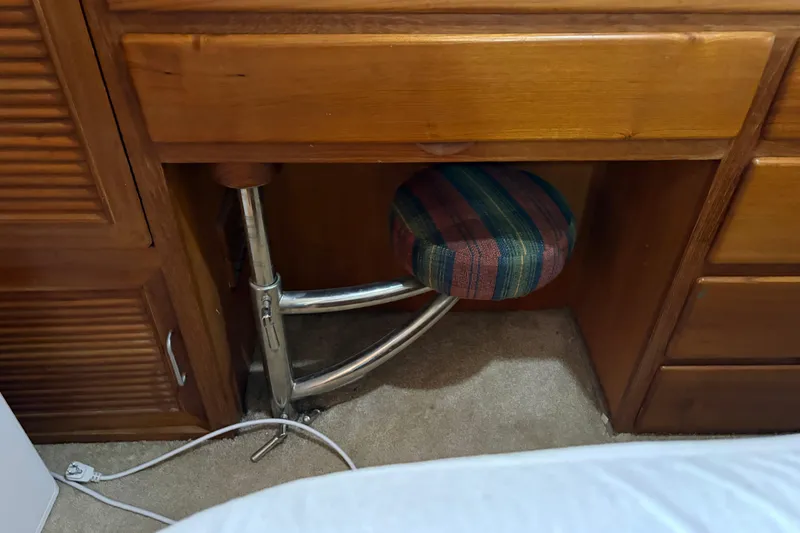 Slide: The Image of Wooden desk with a striped stool underneath, CHB Ponderosa 1986 model. - 39