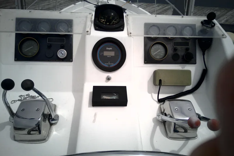 Slide: The Image of Control panel of a 1986 CHB Ponderosa boat with gauges and levers. - 13