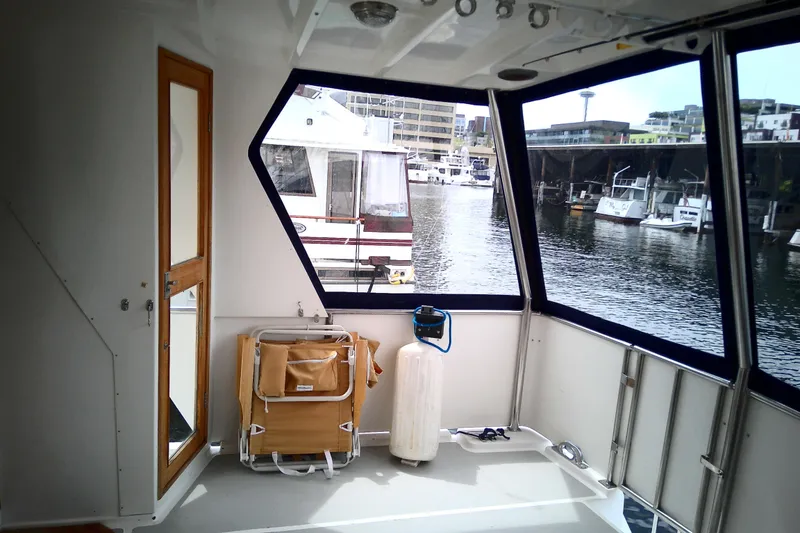 Slide: The Image of Interior view of 1986 CHB Ponderosa boat with marina backdrop. - 19