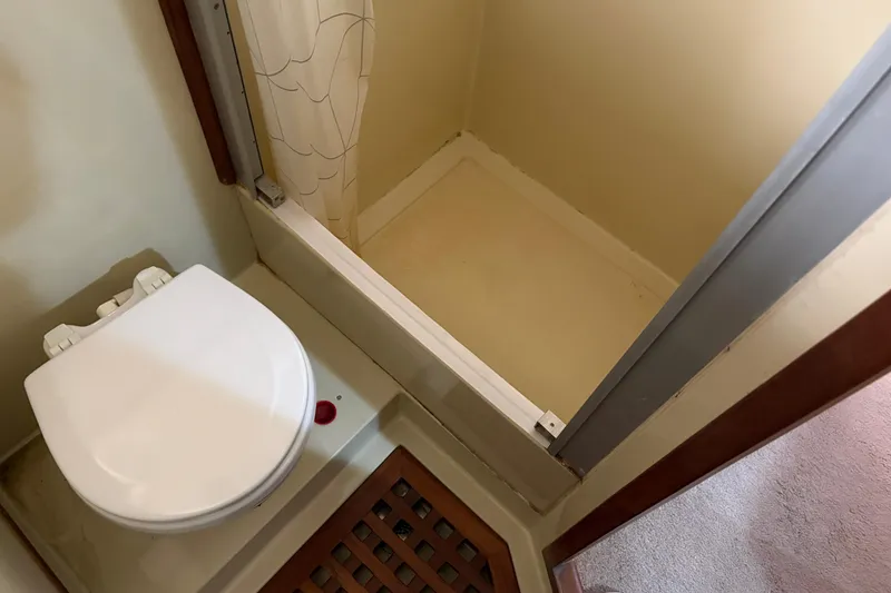 Slide: The Image of Compact bathroom with toilet and shower in 1986 CHB Ponderosa boat. - 38