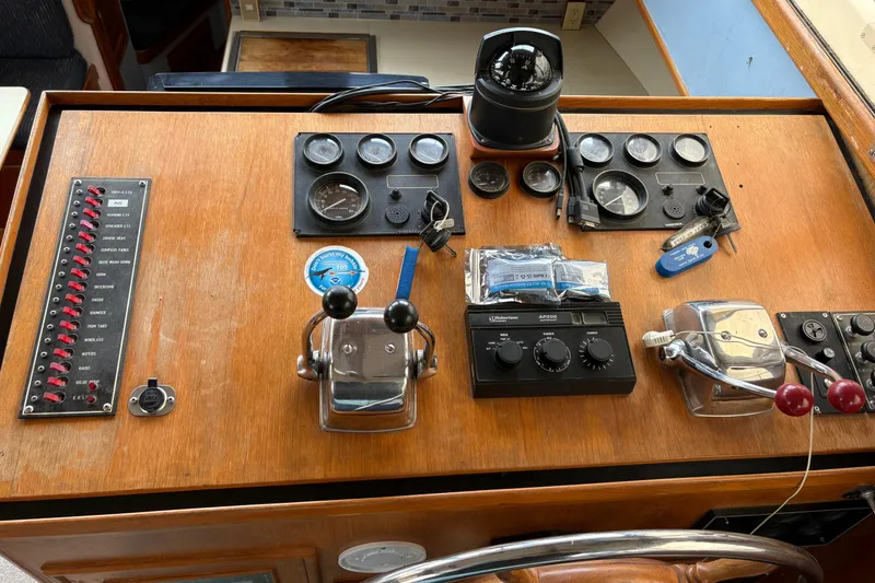 Slide: The Image of 1986 CHB Ponderosa boat dashboard with gauges, controls, and navigation equipment. - 25