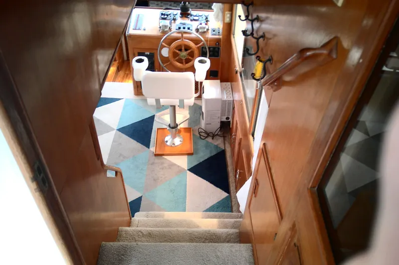 Slide: The Image of Interior of 1986 CHB Ponderosa boat showing helm with wooden wheel and geometric rug. - 20