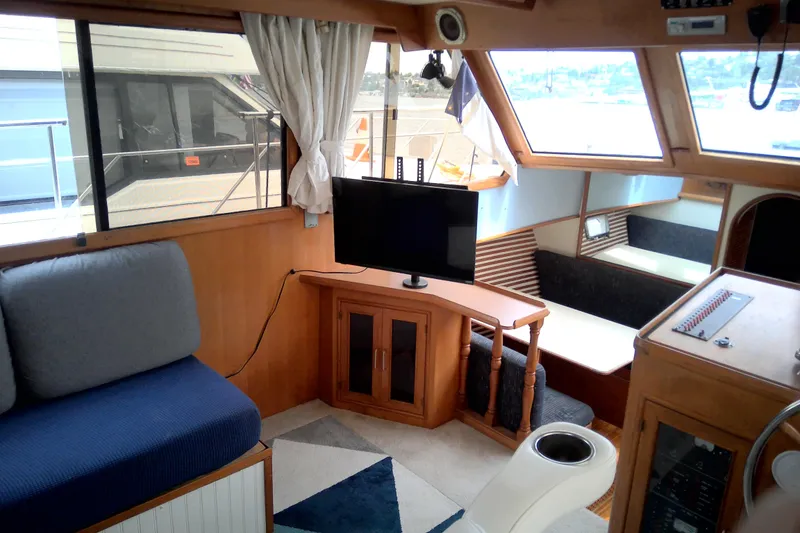 Slide: The Image of Interior of 1986 CHB Ponderosa yacht with cozy seating and mounted TV. - 21