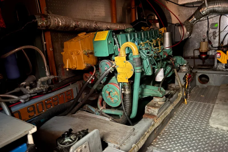 Slide: The Image of Engine room of a 1986 CHB Ponderosa boat, featuring a detailed view of the machinery. - 43